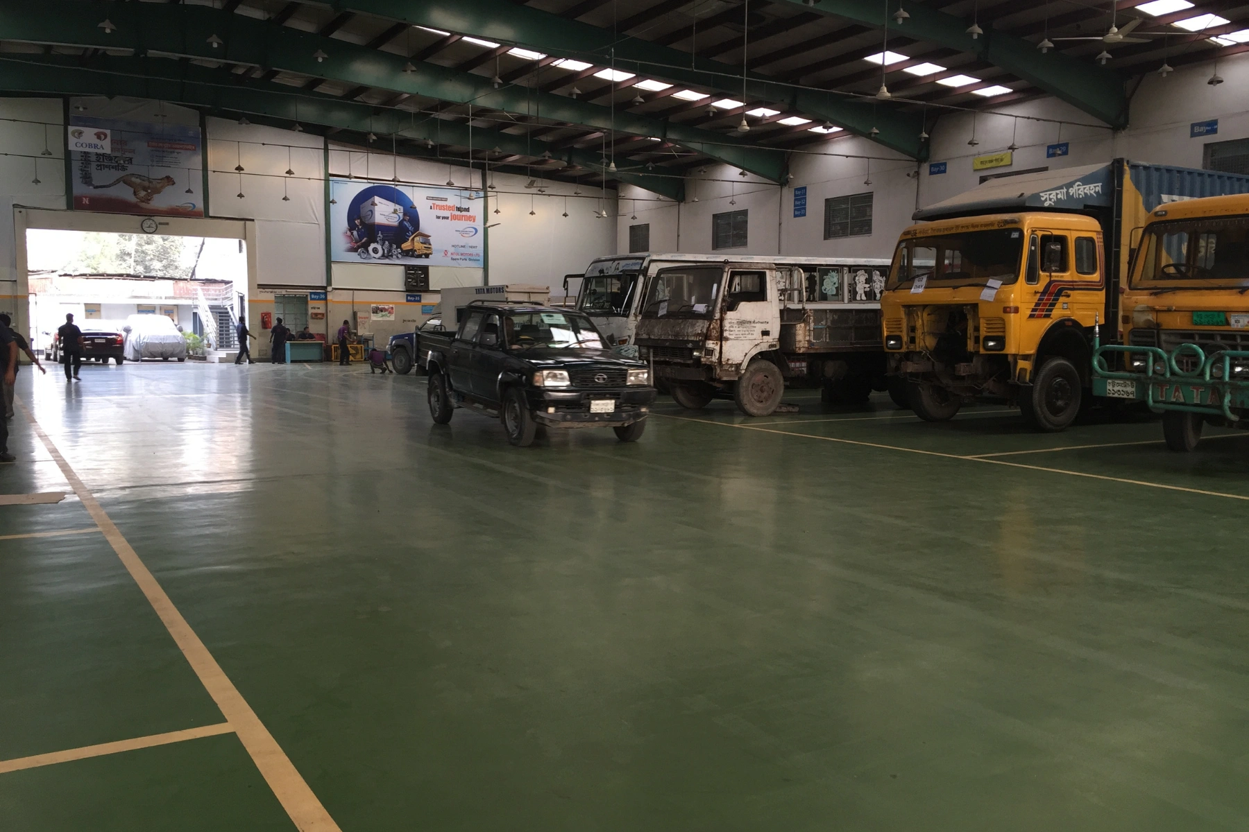 Green resin flooring in a vehicle parking and service area